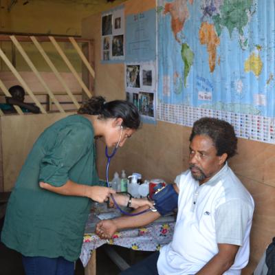 A volunteer doing a routine checkup on a man at her placement in Ghana A Projects Abroad volunteer doing a basic checkup on man at her Spring Break Public Health placement in Ghana